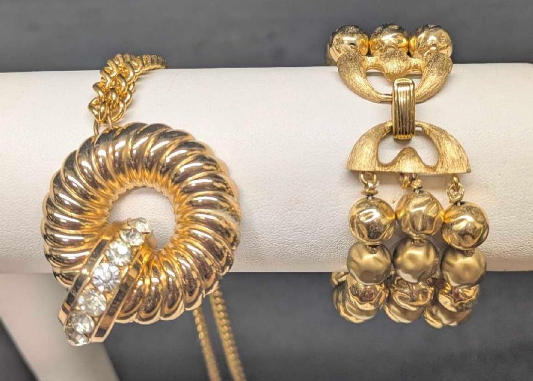 Trifari Gold Tone Bracelet And Rhinestones Brooch: Trifari Gold Tone Bracelet And Rhinestones Brooch. This lot includes: (1) Trifari Gold Tone Bracelet. This is approx 7 1/2". (1) Gold Tone With White Rhinestones Brooch With Chain. This is approx