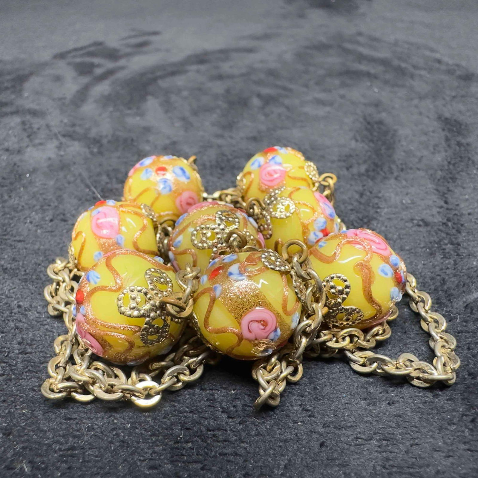 Murano Venetian Art Glass Lamp Work Yellow Beaded Gold Toned Chain Necklace C6: Murano Venetian Art Glass Lamp Work Yellow Beaded Gold Toned Chain Necklace C6. Necklace with yellow colored glass beads with beautiful hand painted designs on each. The necklace features gold and pi
