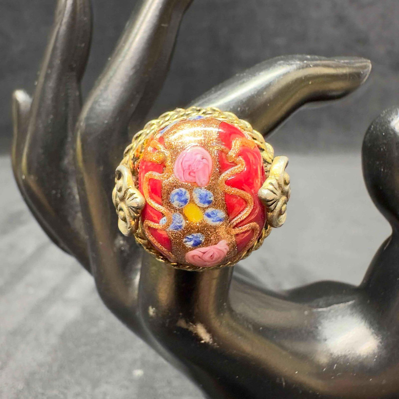 Murano Venetian Lamp Work Art Glass Dark Red Floral Bead Ring F55: Murano Venetian Lamp Work Art Glass Dark Red Floral Bead Ring Necklace F55. Ring with dark red colored glass bead with a beautiful hand painted design. The ring features copper colored and floral acce