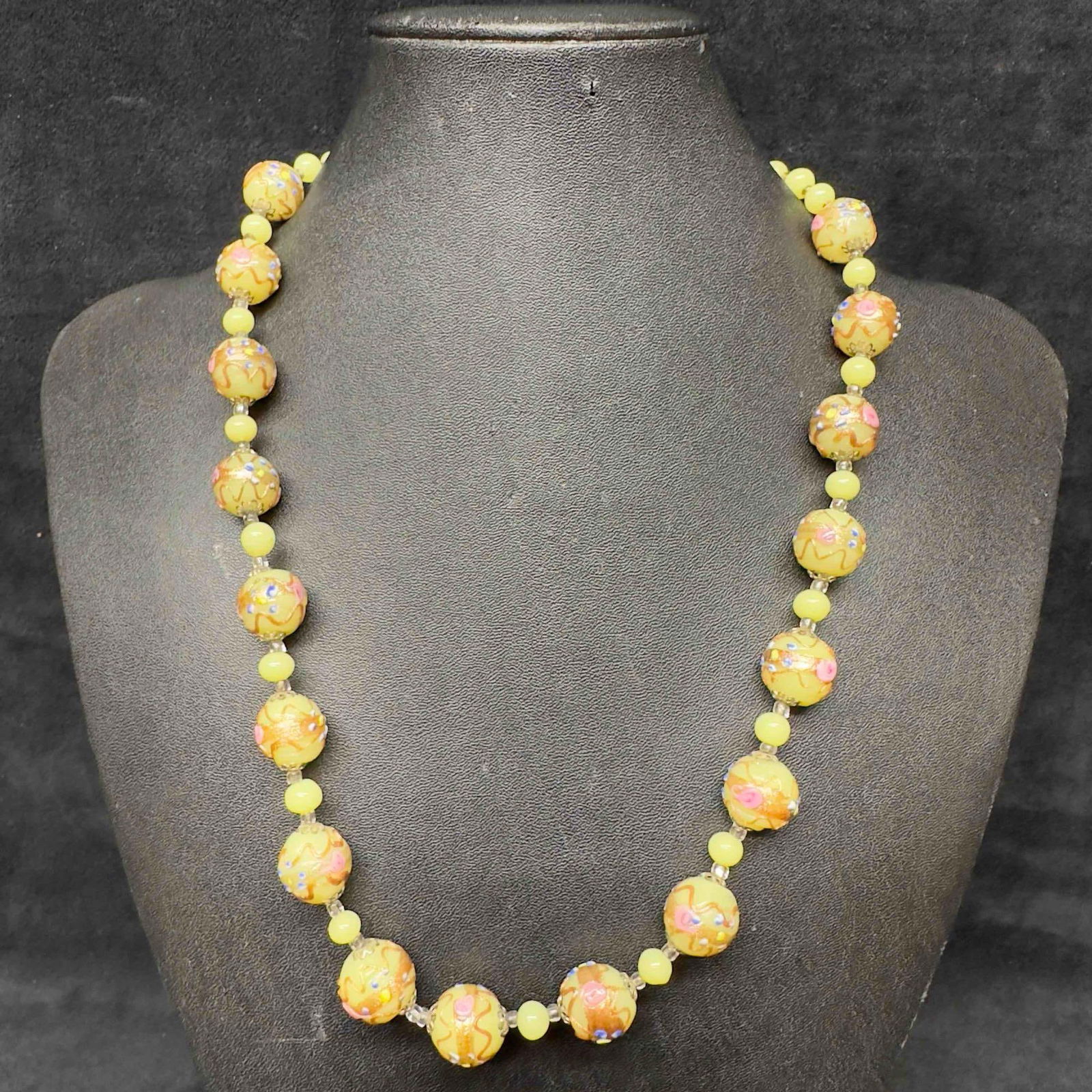 Venetian Murano Glass Lamp Work Round Yellow Bead Necklace: Venetian Murano Glass Lamp Work Round Yellow Bead Necklace. Necklace with yellow glass round beads with beautiful hand painted floral designs on each. The necklace features a barrel screw clasp. This