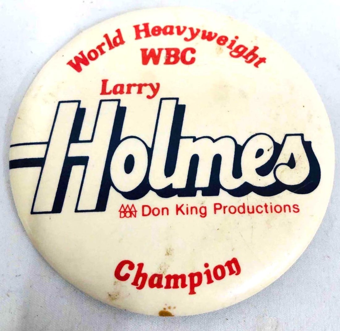Vintage World Heavyweight WBC Champion Larry Holmes Don King Productions Pin: This lot contains a Vintage World Heavyweight WBC Champion Larry Holmes Don King Productions Pin. It is approx 3 1/2" x 3 1/2" and it weighs about 0.04lbs. Overall the Pin is in good used condition wi