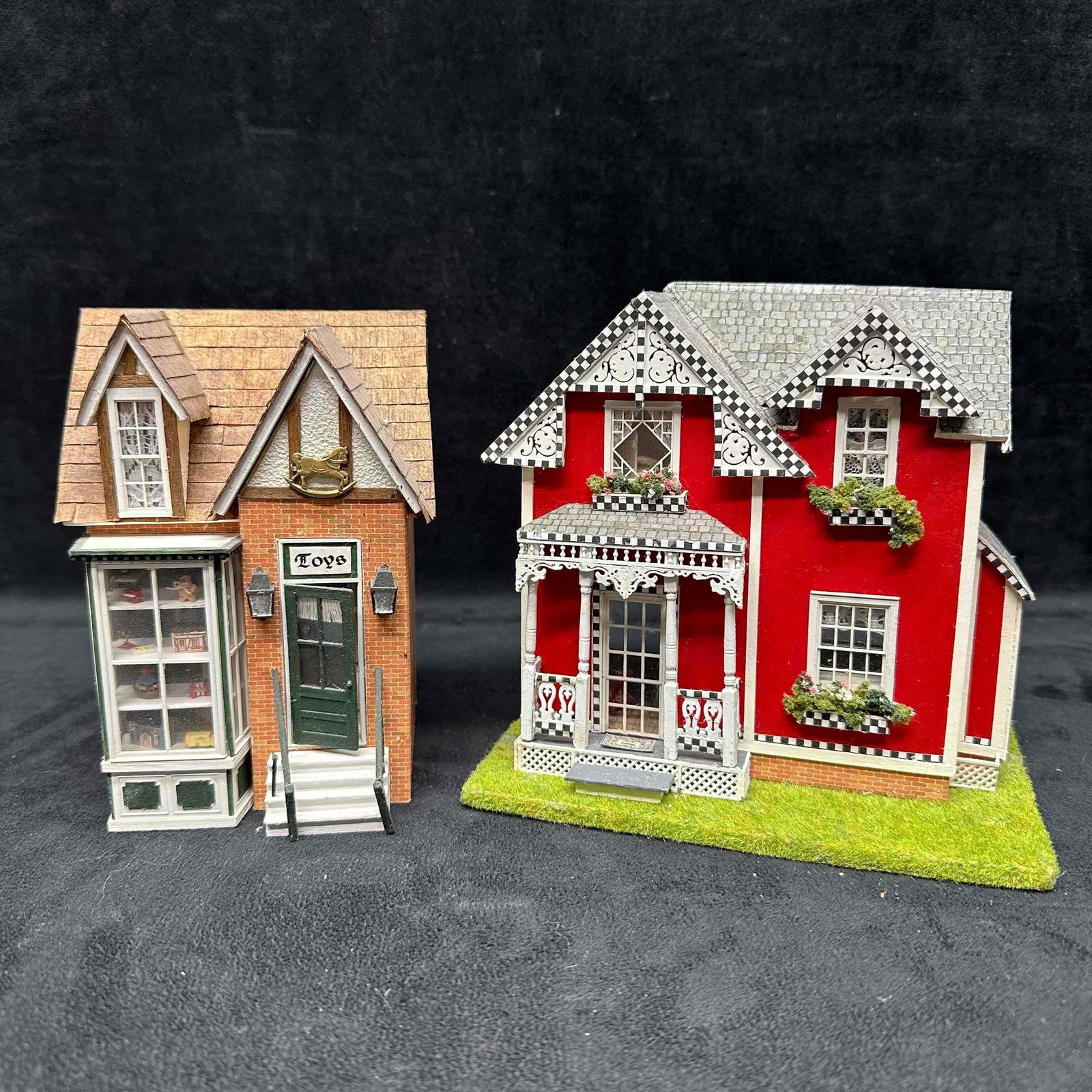 Pair of Handcrafted Miniature Dollhouses Toy Shop and Victorian Style Home: Lot of two handcrafted miniature dollhouses. The first is a two-story brick-front toy shop with detailed interior including rocking horse, dollhouse, shelving, and attic workspace with miniatures. The