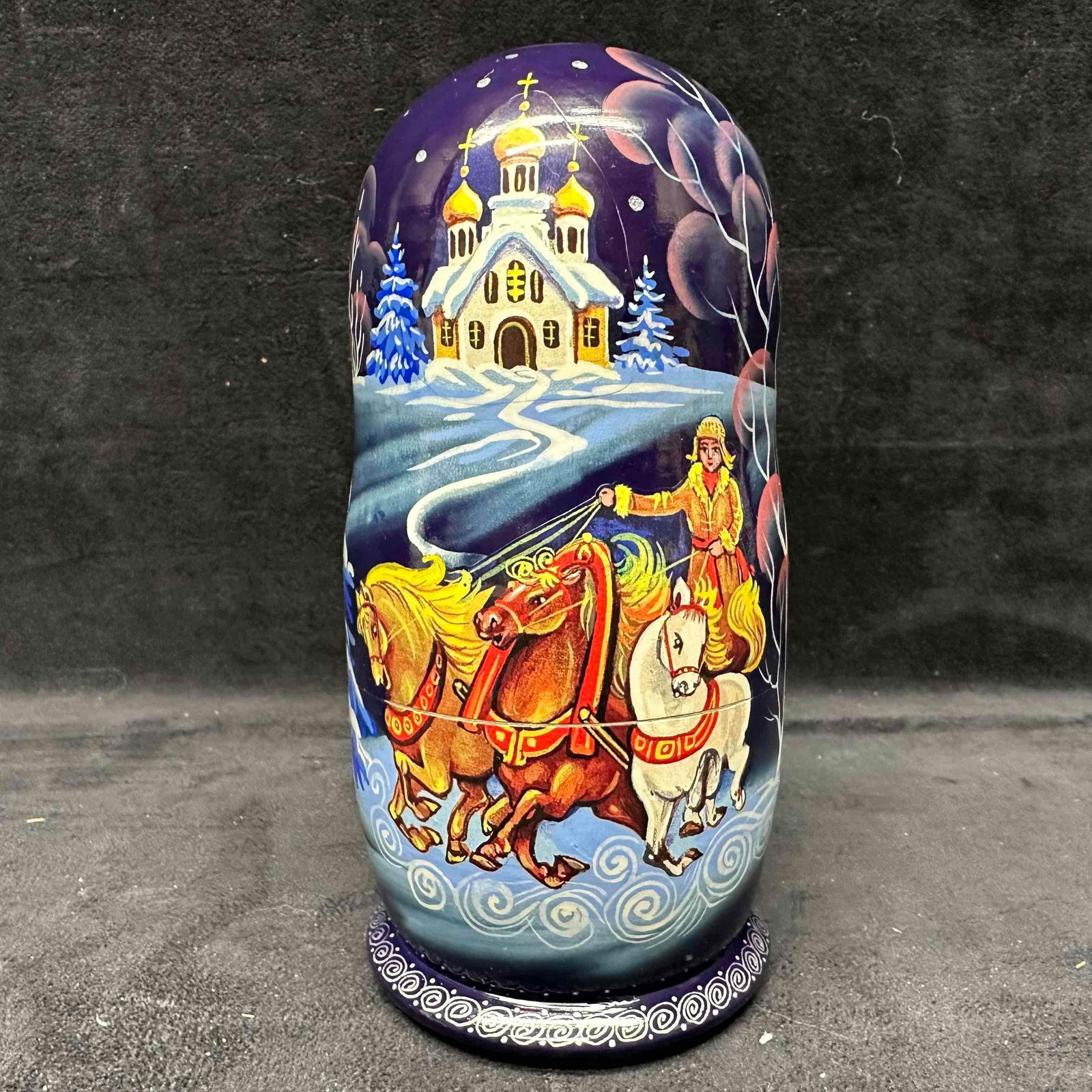Golden Cockerel Russian Hand-Painted Nesting Dolls Set of Nine: Beautiful set of nine Russian nesting dolls by Golden Cockerel, hand-painted with winter troika (three-horse sleigh) and church scene designs. Each doll features detailed artwork on a deep blue backgr