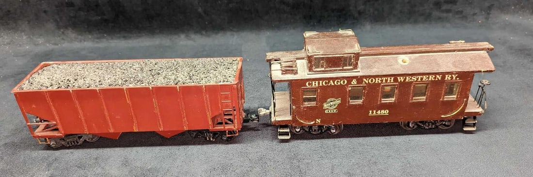 2 Vintage Distressed 0 Scale Coal Hopper & Caboose: 2 Vintage Distressed 0 Scale Coal Hopper & Caboose. This lot includes: (1) Coal Hopper. This is approx 10" x 2 1/2" x 2 7/8". The coal hopper has markings, chips, and light surface rus