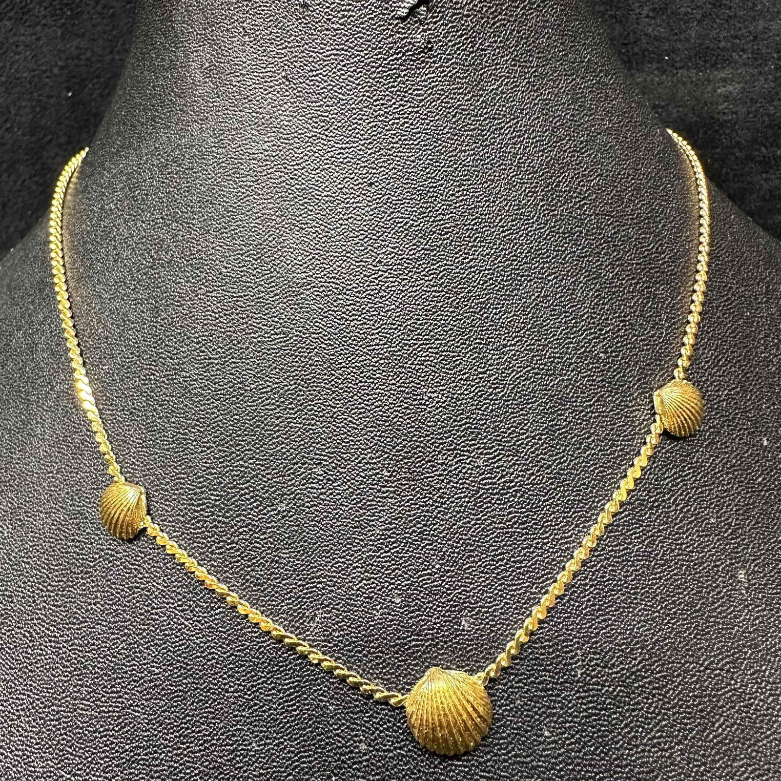 Crown Trifari Gold-Tone Three Seashell Motif Necklace K8: Signed Crown Trifari gold-tone necklace featuring three textured seashell motifs set along a delicate chain. Classic mid-century design with a polished and textured finish, showcasing Trifari’s sign