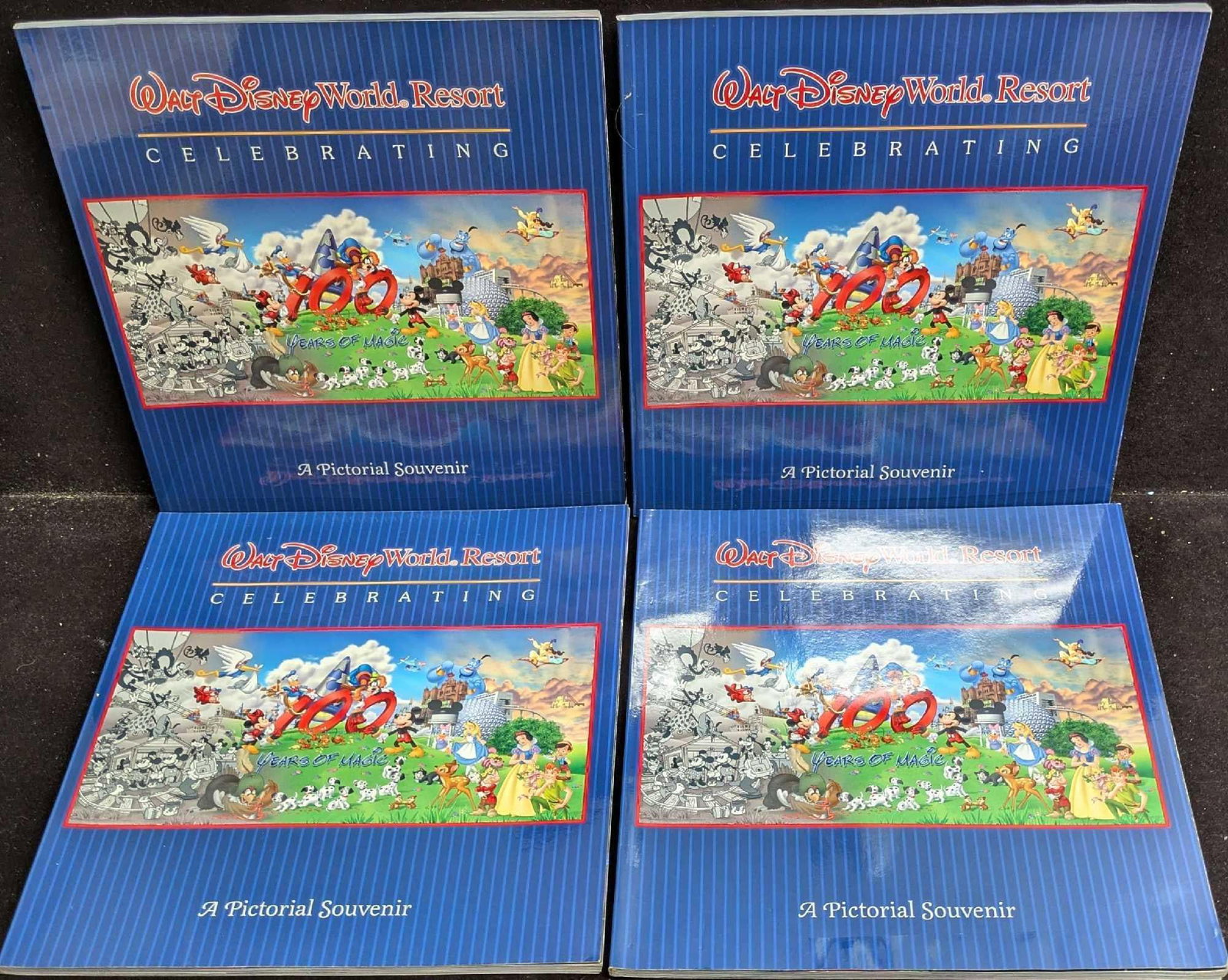 Lot of 4 Walt Disney World 2001 Pictorial Souvenir Books: This lot consists of four 100 years of magic 2001 pictorial souvenir books. They contain photos and facts of Walt Disney World throughout 100 years. The photos are high quality with a lot of details c