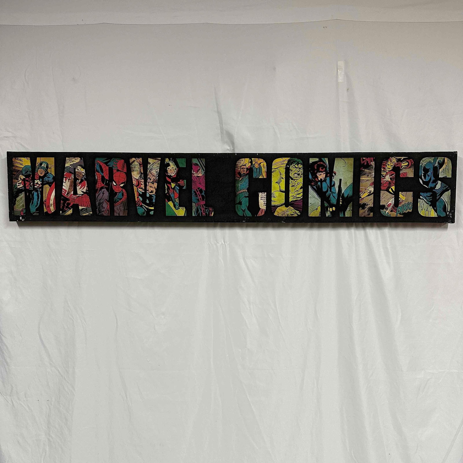Marvel Comics Canvas Wall Art 50 x 8: Large long wall art features marvel comic characters. Original tag still intact. The canvas art show wear with minor white markings. This item is in good pre-owned, previously displayed condition with
