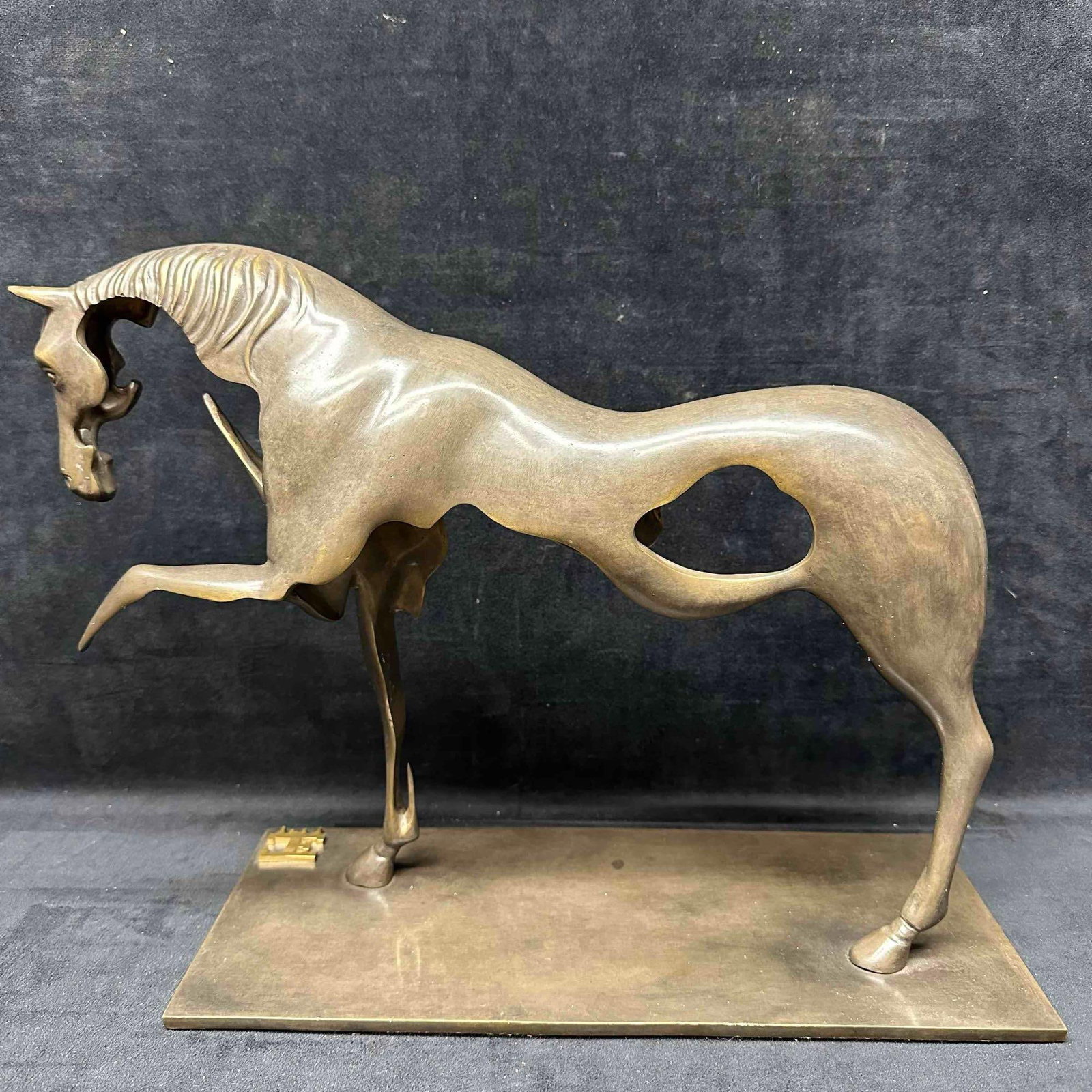 Surrealist Bronze Horse Sculpture in the Style of Salvador Dali J: Surrealist Bronze Horse Sculpture in the Style of Salvador Dali. A striking surrealist bronze sculpture depicting a skeletal, abstract horse, crafted in the distinctive style of Salvador Dali. The hor