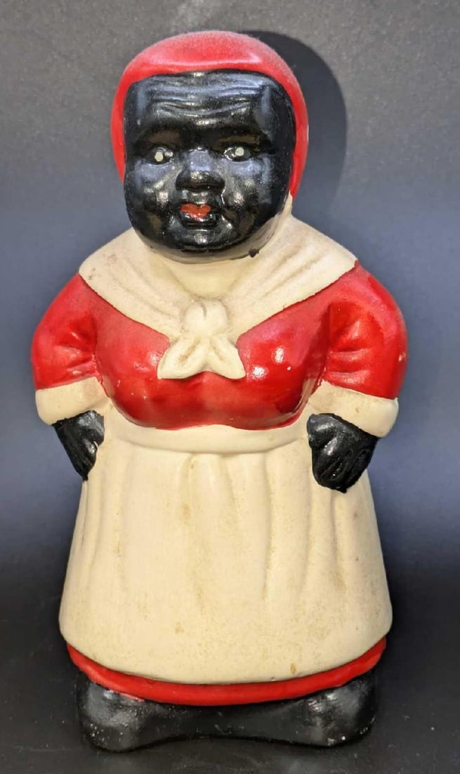 Black Americana Mammy Ceramic Coin Bank: Black Americana Mammy Ceramic Coin Bank. This hand-painted ceramic bank is approx 4" x 4" x 7 1/2" and it weighs 0.88lb. The bank has some markings and color loss. Please see the images as they are pa
