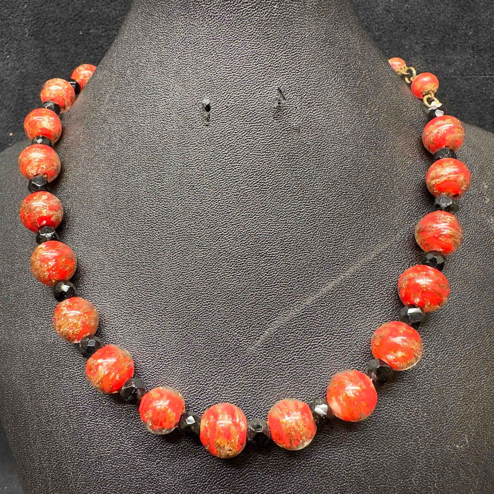 Venetian Murano Lamp Work Art Glass Red and Black Colored Copper Infused Beaded Necklace C36: Venetian Murano Lamp Work Art Glass Red and Black Colored Copper Infused Beaded Necklace C36. Necklace with red and black colored glass beads with beautiful designs on each. The necklace features copp