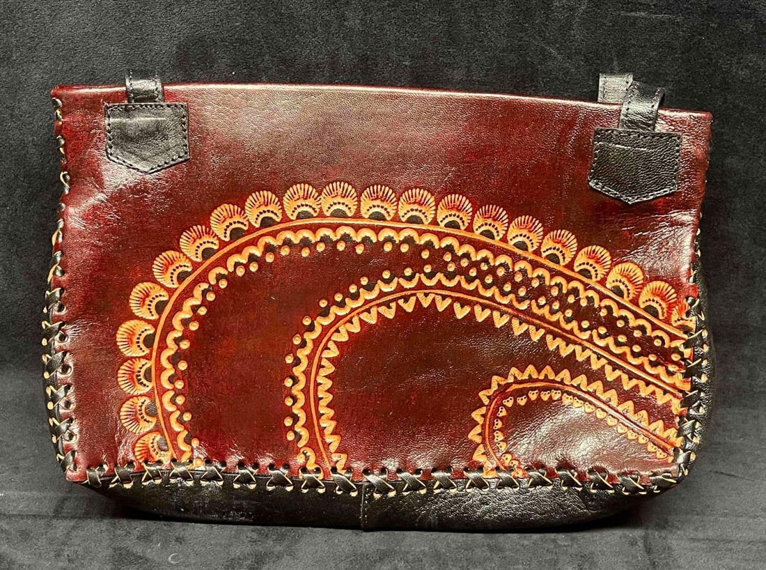 Vintage Leather Handicraft Purse Embossed Flowers (5): This lot contains a Vintage Leather Handicraft Purse With Embossed Flowers (5). The bag is hand-stitched and has a very soft leather liner and inside zipper pocket. It is approx 12" x 3" x 2" and it w