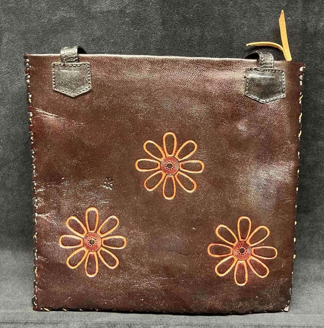 Vintage Leather Handicraft Purse Embossed Flowers (1): This lot contains a Vintage Leather Handicraft Purse With Embossed Flowers (1). The bag is hand-stitched and has a very soft leather liner and inside zipper pocket. It is approx 10 1/2" x 1/2"