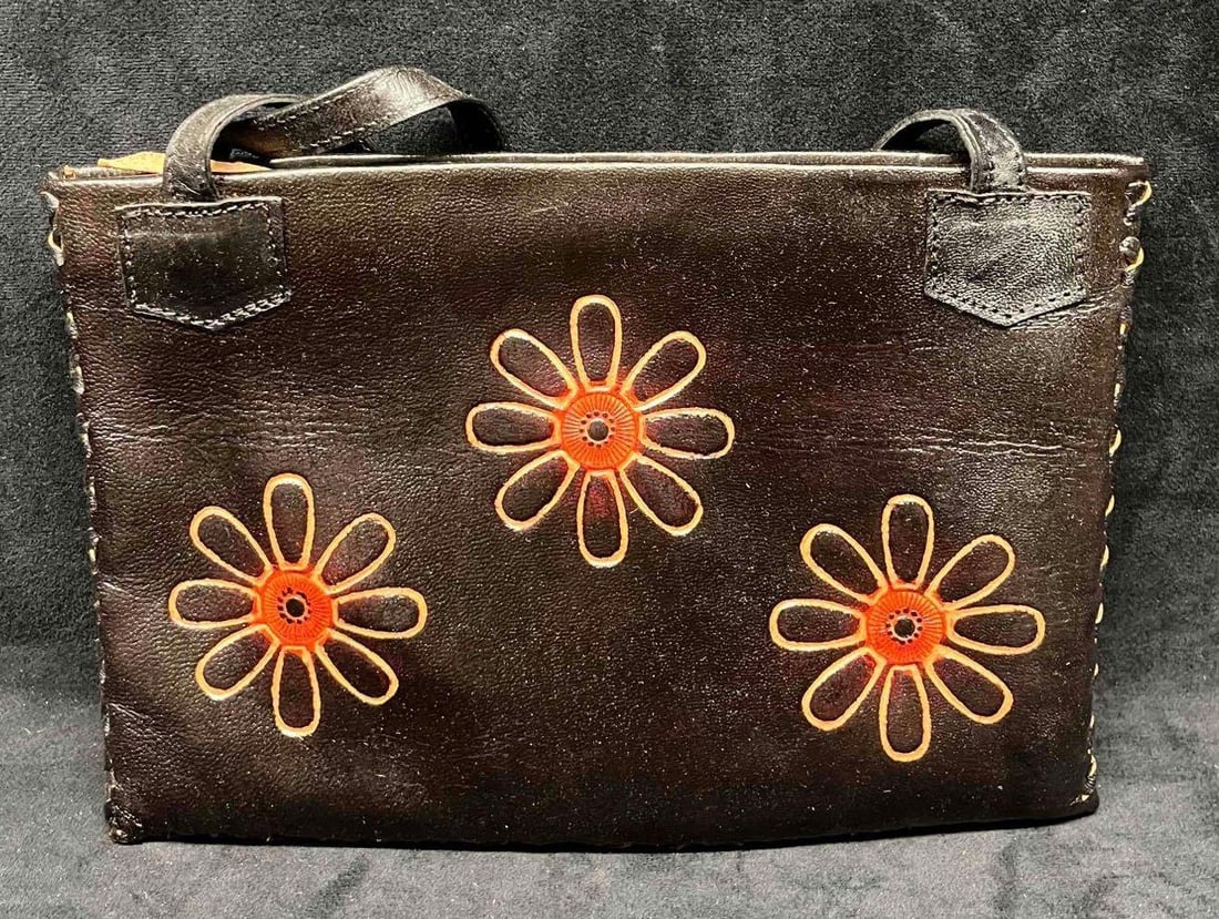 Vintage Leather Handicraft Purse With Embossed Flowers (16): This lot contains a Vintage Leather Handicraft Purse With Embossed Flowers (16). The bag is hand-stitched and has a very soft leather liner and inside zipper pocket. It is approx 10 1/2" x 1/2" x 7 1/