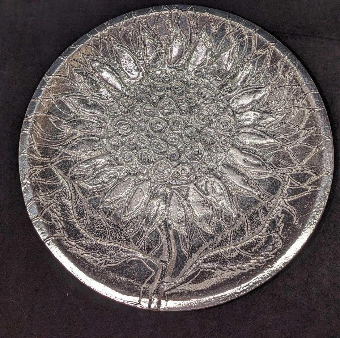 Don Drumm Aluminum Sunflower Bowl: Don Drumm Aluminum Sunflower Bowl. This is approx 13 5/8" x 13 5/8" x 2 1/8" and it weighs 4.93lbs. The bowl is in good, used condition with no known damage. The bowl includes a hole in the base on th