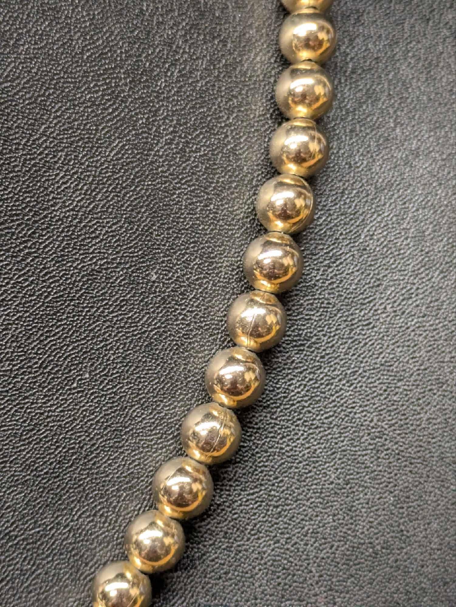 Vintage Monet Gold Tone Beaded Necklace Lot of 2: Vintage Monet Gold Tone Beaded Necklace Lot of 2. This lot includes: (1) Monet Gold Tone Glossy Beaded Necklace. This is approx 19". (1) Monet Gold Tone Textured Beaded Necklace. This is approx 1