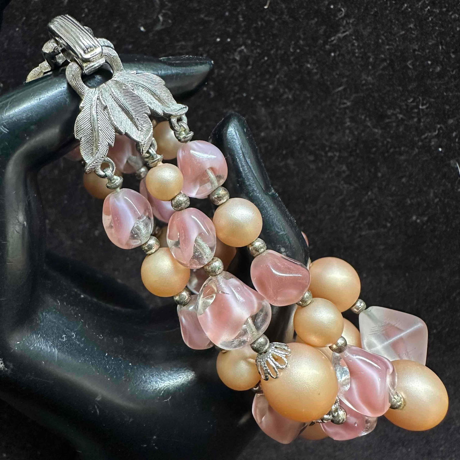 Crown Trifari Pink Peach Toned Plastic and Glass Bead Bracelet: Triple strand bracelet with vintage crown Trifari hallmark on the clasp. This items is in good pre-owned, previously displayed condition with light wear, and surface scratches. Please reference all ph