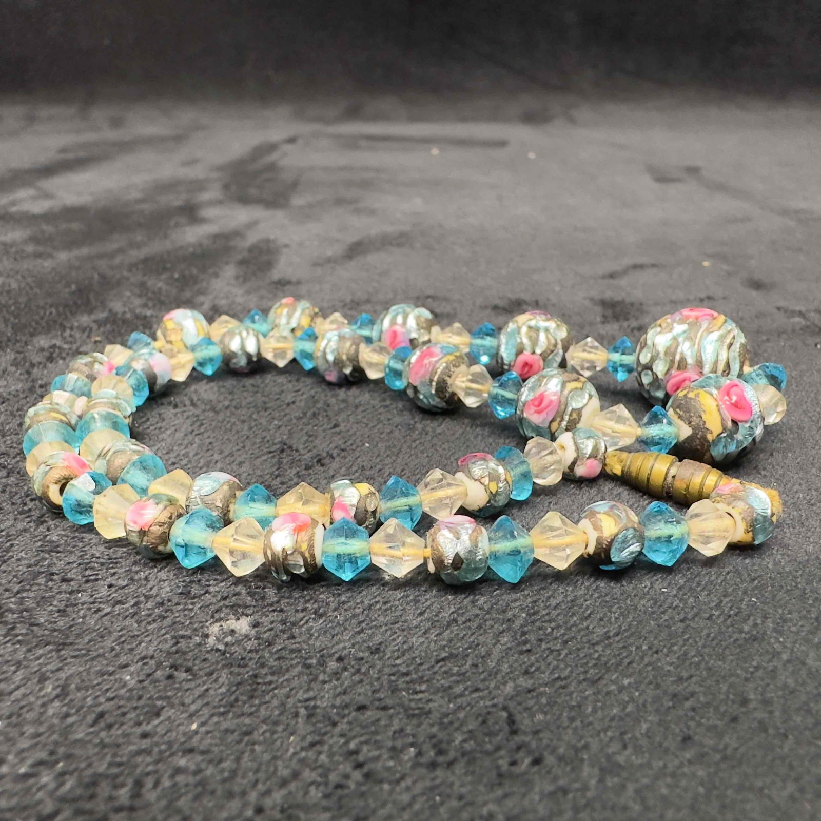 Venetian Murano Lamp Work Glass Light Blue Floral Beaded Necklace B47: Venetian Murano Lamp Work Glass Light Blue Floral Beaded Necklace B47. Necklace with blue colored glass beads with beautiful designs on each. The necklace feature floral accents. The necklace features