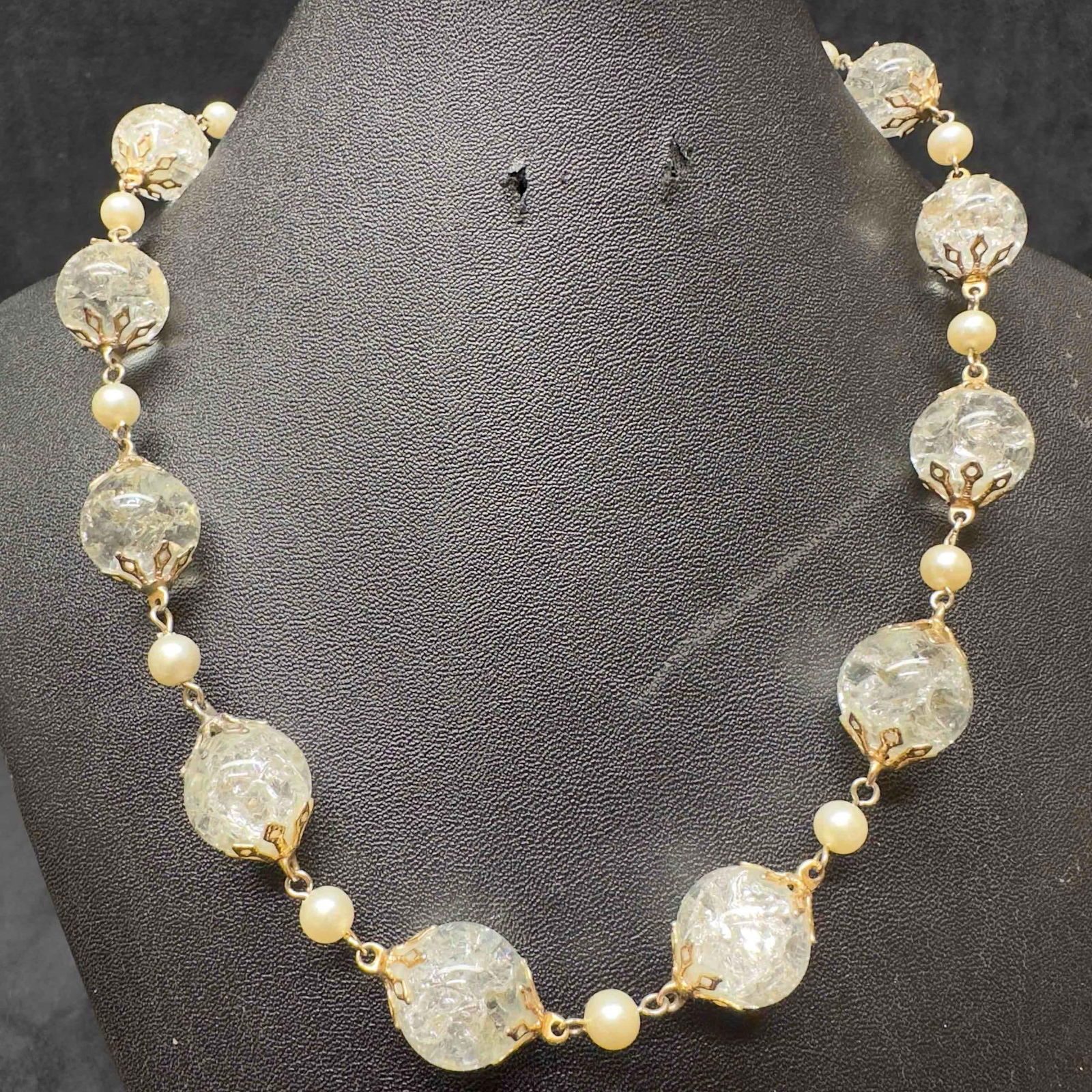 Murano Venetian Lamp Work Art Glass Clear Beaded Gold Toned Necklace F64: Murano Venetian Lamp Work Art Glass Clear Beaded Gold Toned Necklace F64. Necklace with clear glass beads with a beautiful design on each. The necklace features a gold toned colored chain. The necklac