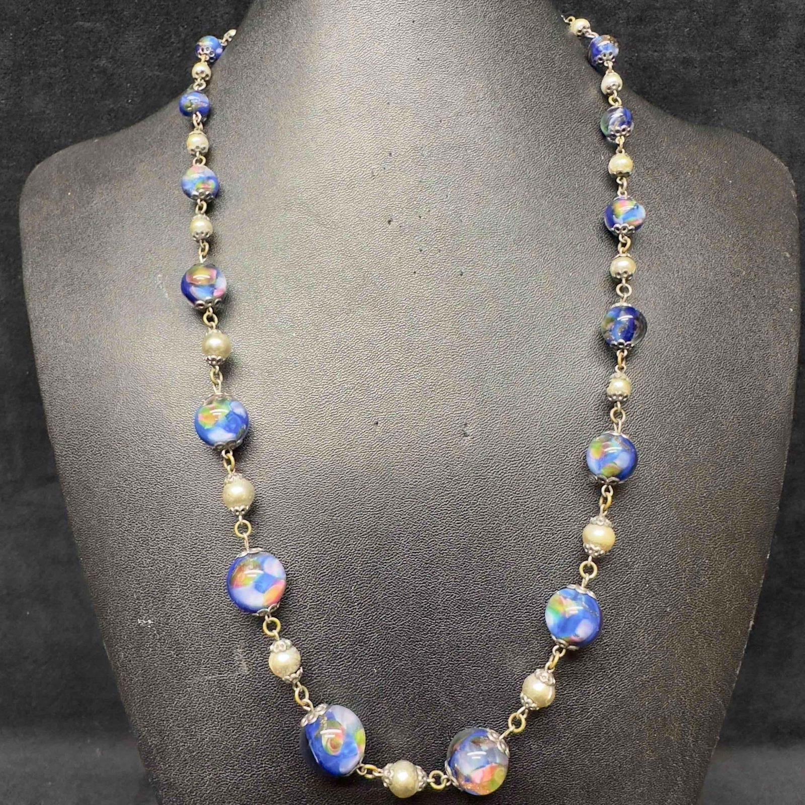 Venetian Murano Art Glass Lamp Work Iridescence Blue Beaded Necklace D11: Venetian Murano Art Glass Lamp Work Iridescence Blue Beaded Necklace D11. Necklace with blue colored glass beads with beautiful designs on each. The necklace features Iridescence accents. The necklace