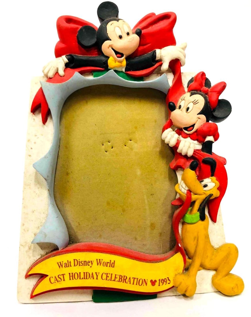 Walt Disney World Cast Holiday Celebration 1993 Photo Frame: This lot contains a Walt Disney World Cast Holiday Celebration 1993 Photo Frame. It is approx. 8 1/2" x 6 1/4" and it weighs about 0.9lbs. Overall the frame is in good used condition with some light w
