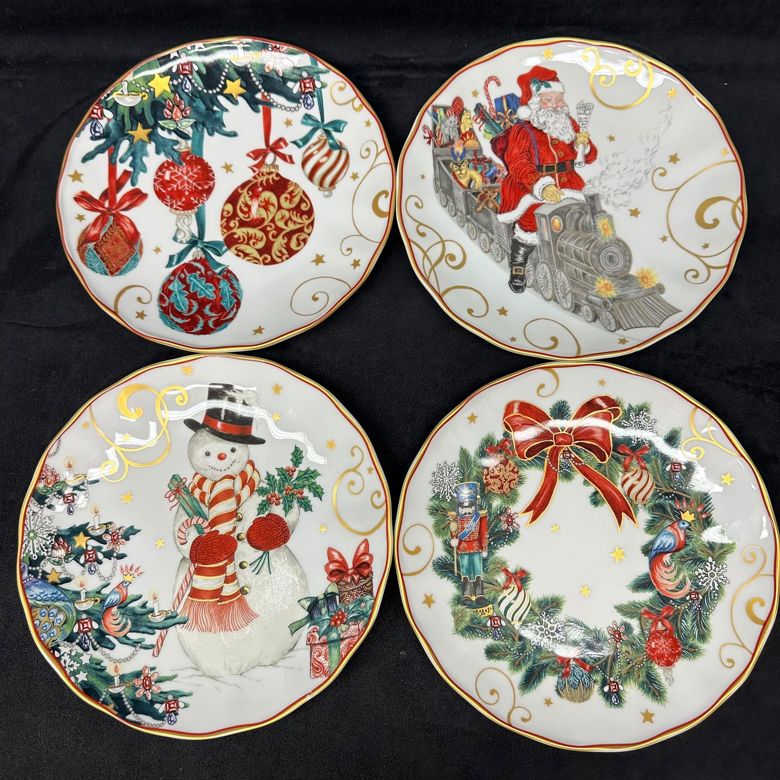 Set of 4 Williams Sonoma Christmas Plates Santa Snowman Wreath and Ornaments: Set of four decorative porcelain holiday plates made exclusively for Williams Sonoma. Each plate features a unique festive design, including Santa on a toy train, a snowman with gifts, a Christmas wre