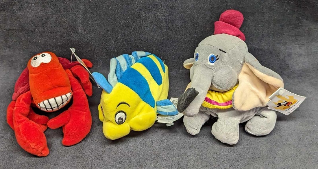 3 Disney The Little Mermaid & Dumbo Bean Bag Dolls: 3 Disney The Little Mermaid & Dumbo Bean Bag Dolls. This lot includes: (1) Flounder (The Little Mermaid) Bean Bag Doll. This is approx 7" x 3 1/2" x 4". (1) Sebastian (The Little Merma
