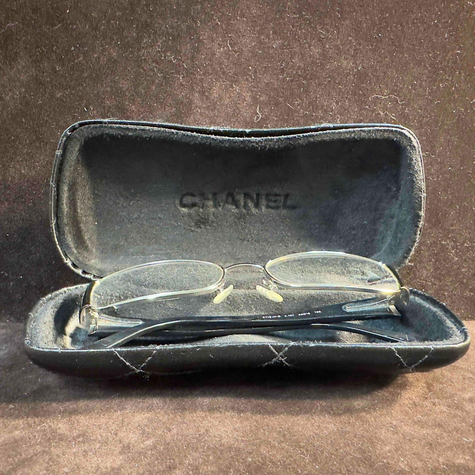 Chanel 218-H-B C. 127 Black Italy Designer Women's Eyeglasses 52-16-135 with Case: Chanel 218-H-B C. 127 Black Italy Designer Women's Eyeglasses 52-16-135. Chanel eyeglasses includes the Chanel logo on the temples. The black Chanel case has the logo on the front left. The frames