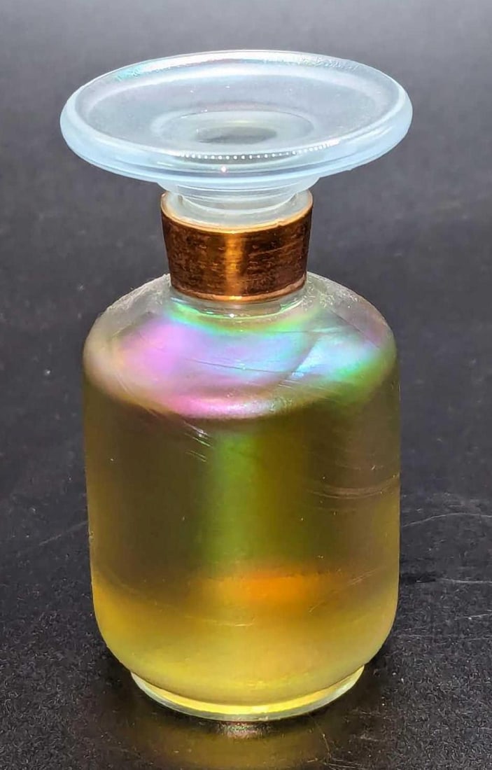 Alexander Julian Perfume Iridescent Glass Bottle: Alexander Julian Perfume Iridescent Glass Bottle. The bottle was made by Fenton and is filled at 1 oz. The bottle is approx 1 1/2" x 1 1/2" x 3" and it weighs 0.22lb. The bottle is nearly filled and h