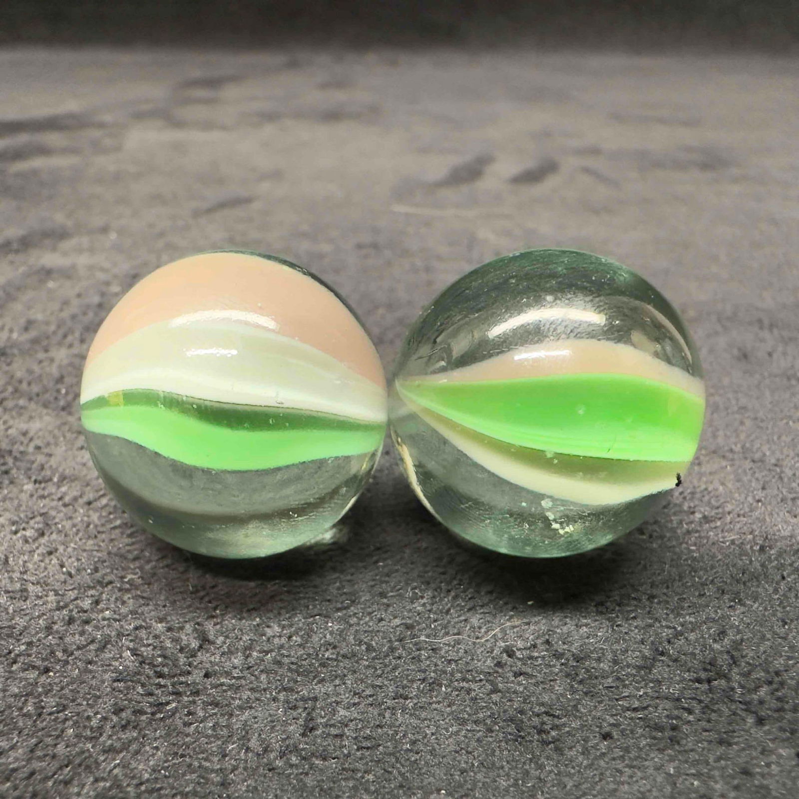 Green Cat Eye Marble Medium 25mm Set: Green Cat Eye Marble Medium 25mm Set. This set of marbles has light marks and a few chips on the glass. These items are in good pre-owned, previously displayed condition with light wear, and surface s