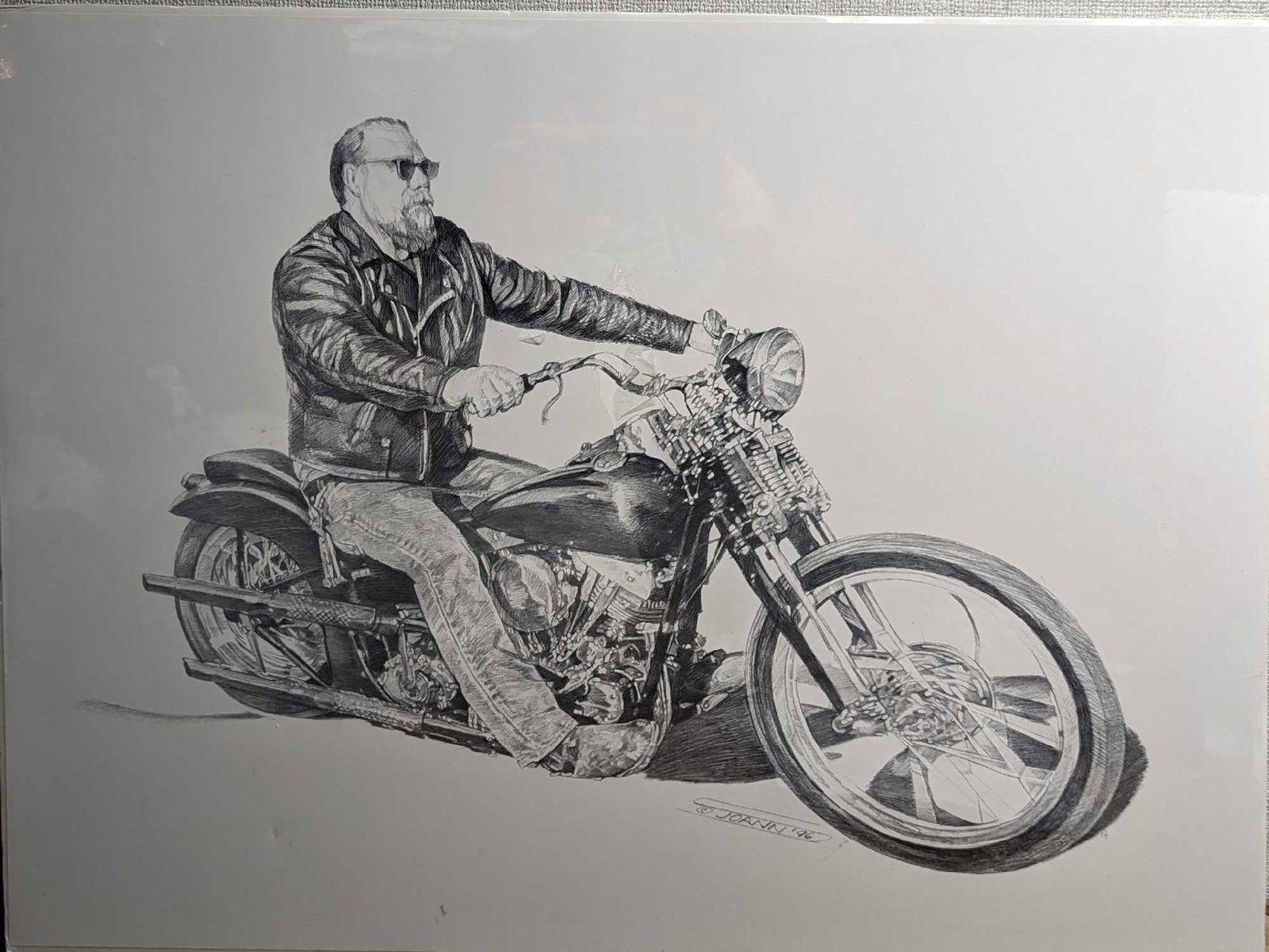 Motorcycle Biker Joann Print: Motorcycle Biker Joann Print. This print is approx 24" x 18" and it weighs 0.57lb. The print has its original wrapping, but there are some small rips near the biker's arms. There are also four very sm