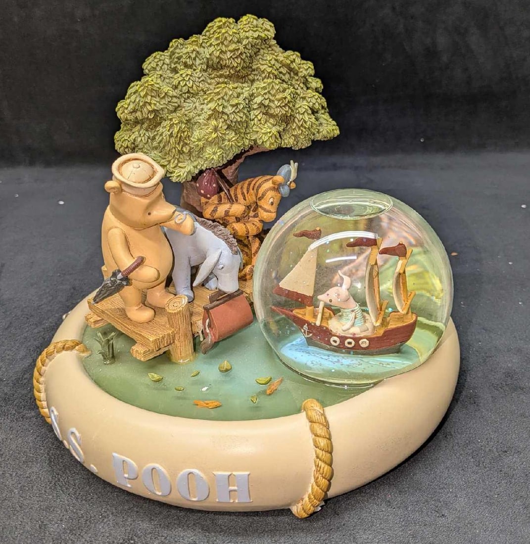 Disney Winnie The Pooh Musical Snoe Globe With Box: Disney Winnie The Pooh Musical Snoe Globe With Box. This plays the "Winnie The Pooh" tune. It comes in the original box that is approx 11 1/4" x 11 1/8" x 9 7/8" and it weighs 7.40lbs. The box has som