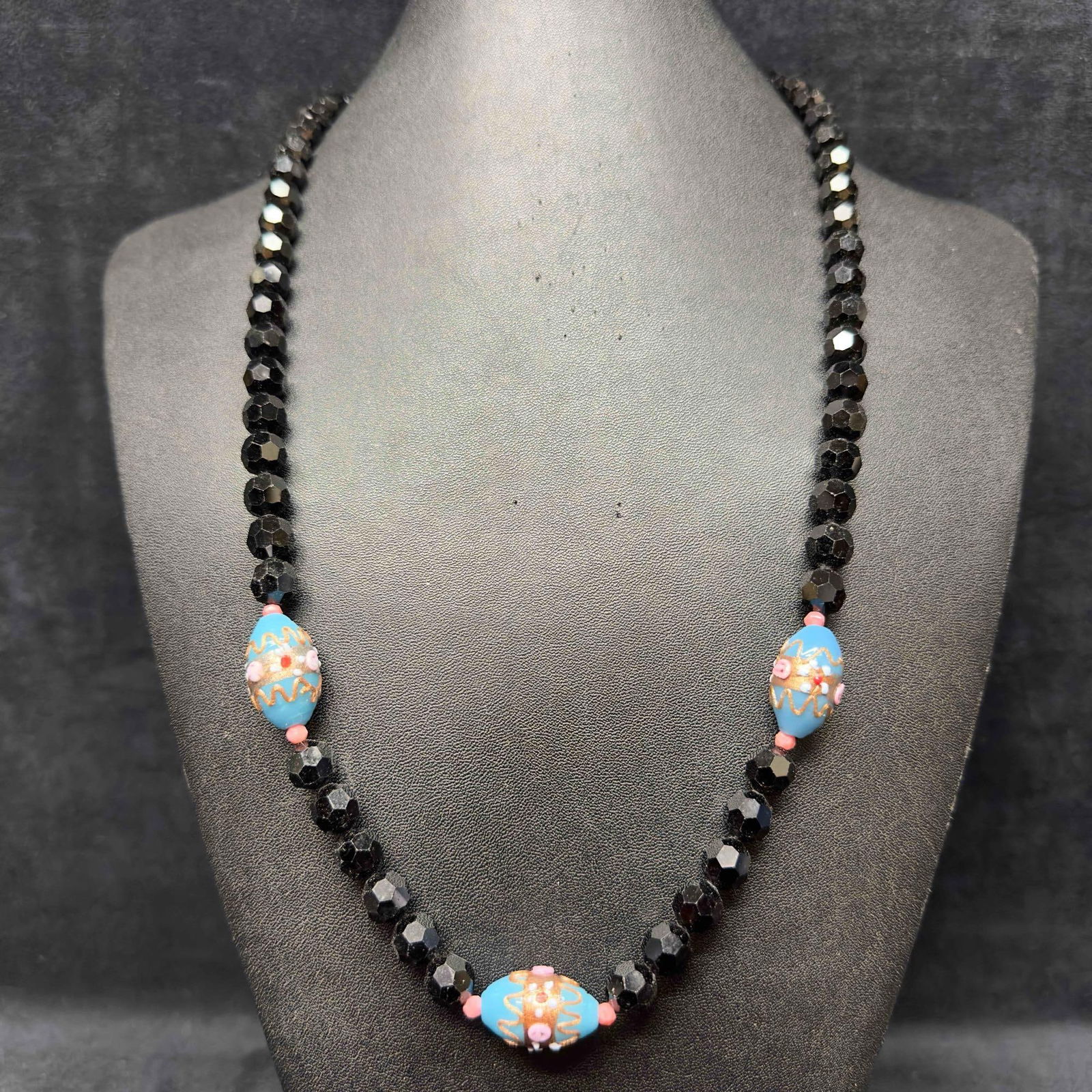 Venetian Murano Art Glass Lamp Work Black Bead Three Oval Floral Blue Beaded Necklace D17: Venetian Murano Art Glass Lamp Work Black Bead Three Oval Floral Blue Beaded Necklace D17. Necklace with black and blue colored glass beads with beautiful designs on each. The necklace features floral
