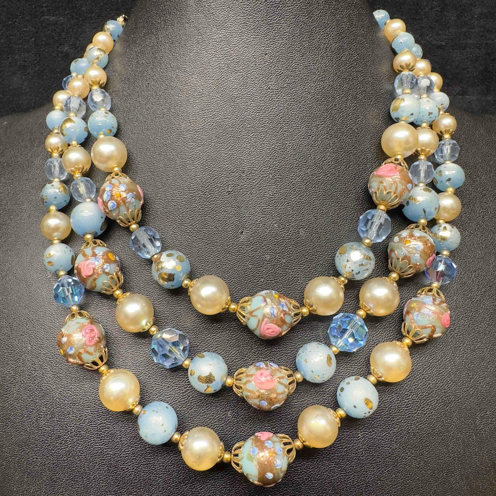 Venetian Murano Lamp Work Glass Art Light Blue Beaded Pearl Gold Accents Triple Layer Necklace E56: Venetian Murano Lamp Work Glass Art Light Blue Beaded Pearl Gold Accents Triple Layer Necklace E56. Necklace with light blue colored glass beads with a beautiful design on each. The necklace features 