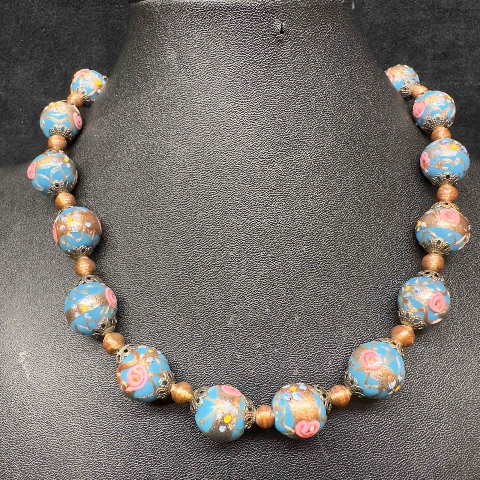 Murano Venetian Art Glass Lamp Work Blue Floral Round Bead Fiorato Beaded Necklace C53: Murano Venetian Art Glass Lamp Work Blue Floral Round Bead Fiorato Beaded Necklace C53. Necklace with blue glass beads with beautiful floral designs on each. The necklace features copper and floral ac