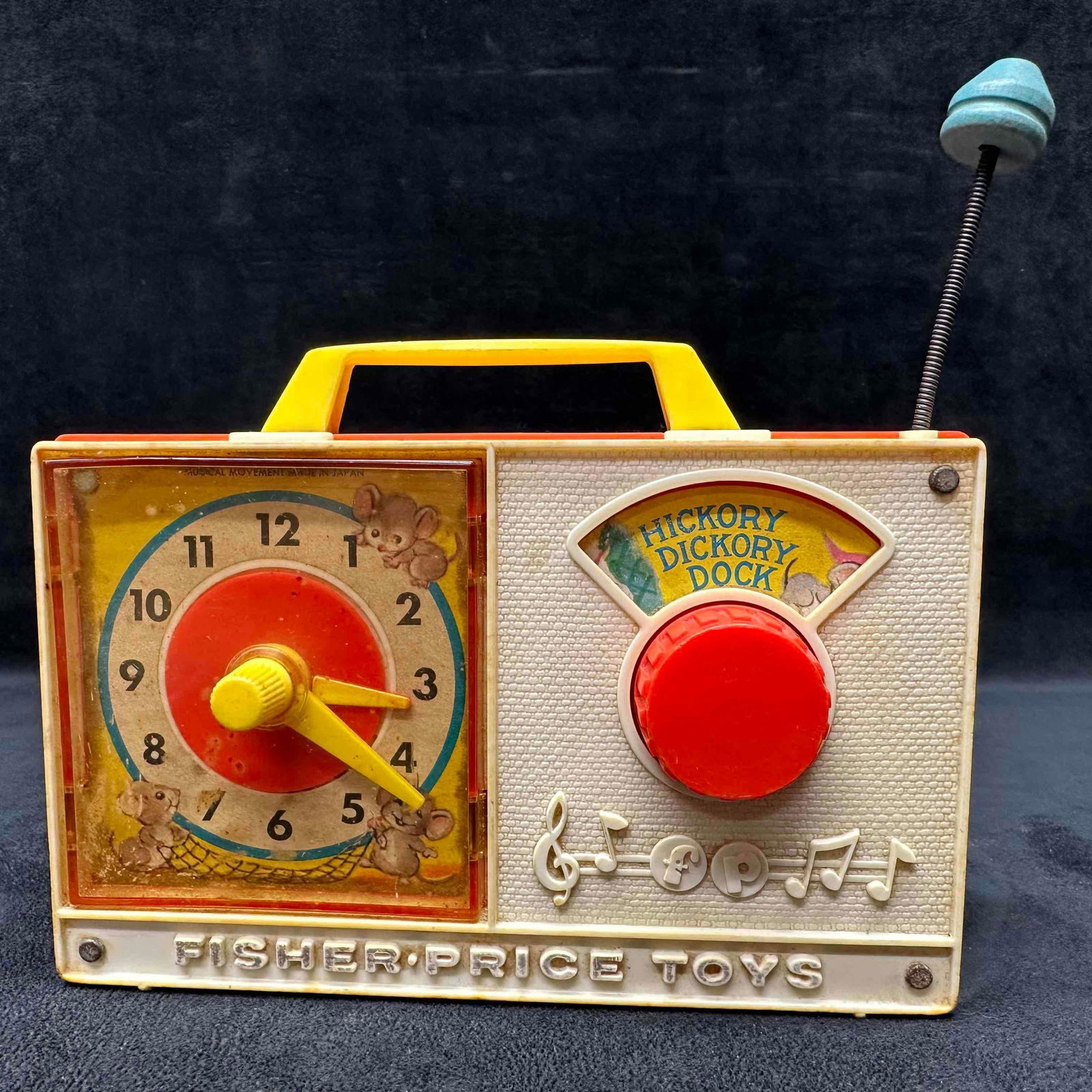 Fisher Price Toys Musical Clock Radio Hickory Dickory Dock #107 Wind-Up 1960's Toy: Fisher Price Toys musical clock radio, model #107, featuring the nursery rhyme "Hickory Dickory Dock." Original red dial and yellow clock hands remain intact. The antenna is still attached wit