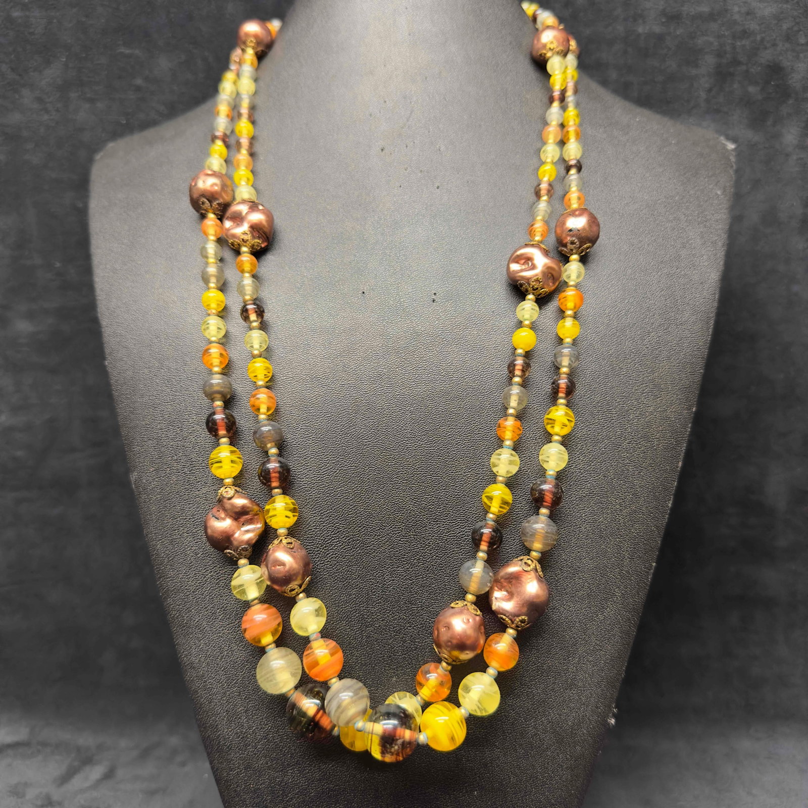 Brown Orange Yellow Green Colored Glass Art Beaded Costume Jewelry Long Necklace H9: Brown Orange Yellow Green Colored Glass Art Beaded Costume Jewelry Long Necklace H9. Necklace with orange, green, yellow, and brown colored glass beads with beautiful designs on each. The necklace fea