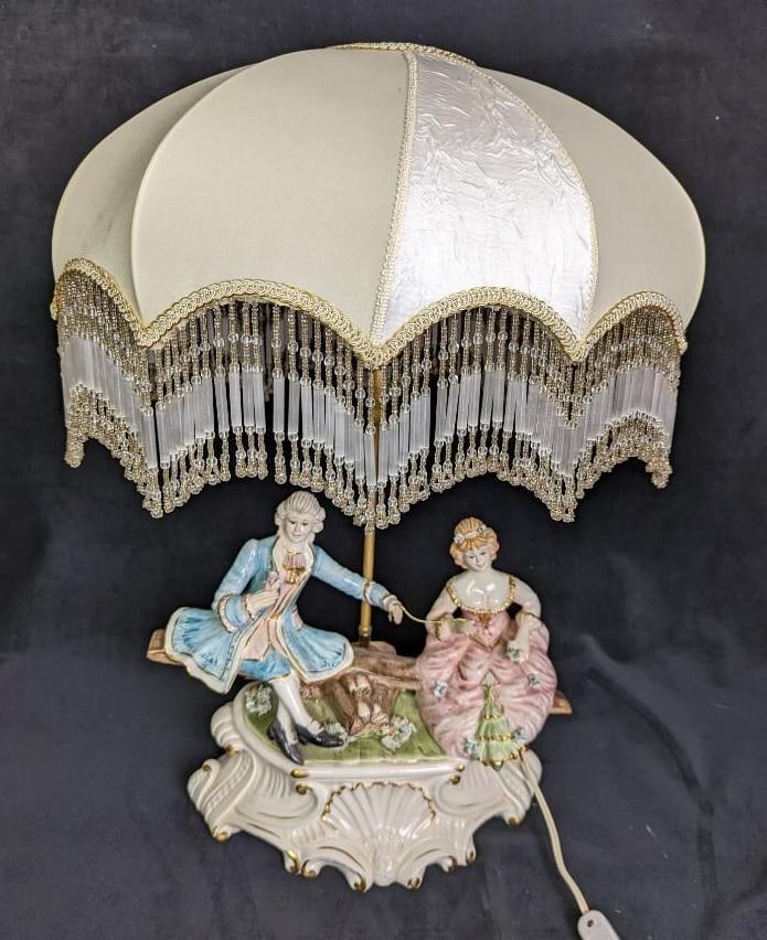 Vintage Capodimonte Porcelain Figural Lamp: Vintage Capodimonte Porcelain Figural Lamp. This lamp is approx 15.5" W x 26' H x 7" L and it weighs 9lbs. The lamp was marked with the maker stamp on the bottom along with the MADE IN ITALY mark