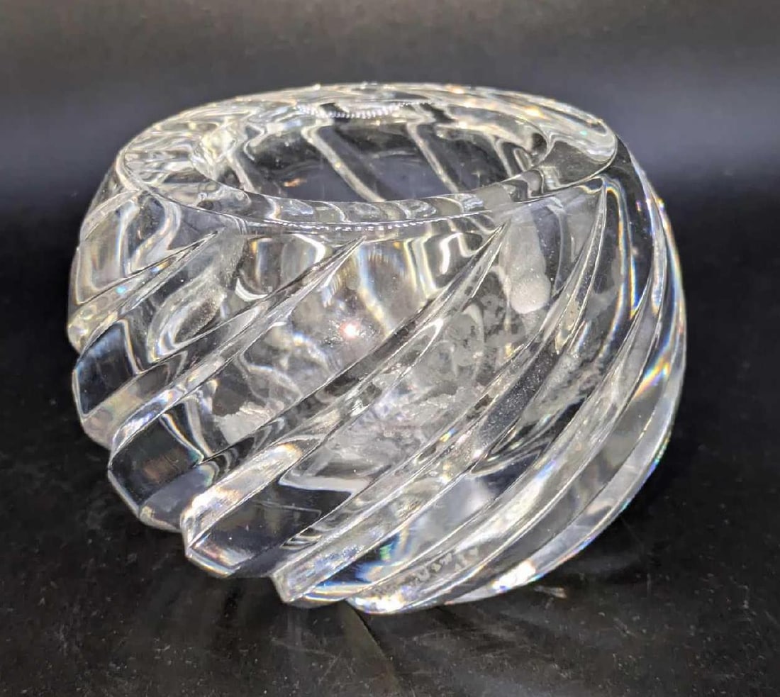 Round Crystal Mid Century Votive Candle Holder: Round Crystal Mid Century Votive Candle Holder. This round crystal Mid-century motive candle holder features an elegant deep swirl pattern and a star cut base. Light illuminates through it and it