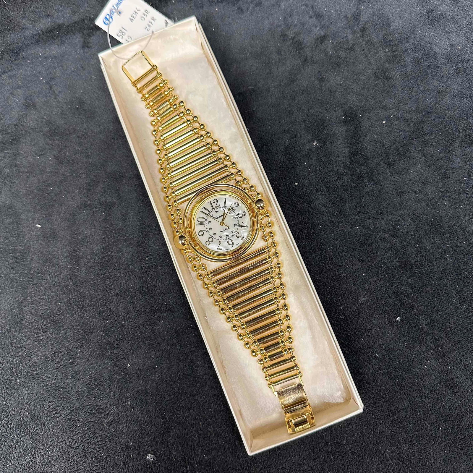 Gold Tone Statement Watch Expanding Style Bracelet Quartz Movement: Bold vintage gold tone statement watch featuring a wide tapered bracelet design with bar and bead accents. White dial with black Arabic numerals and quartz movement. Case back marked Southern Watch In