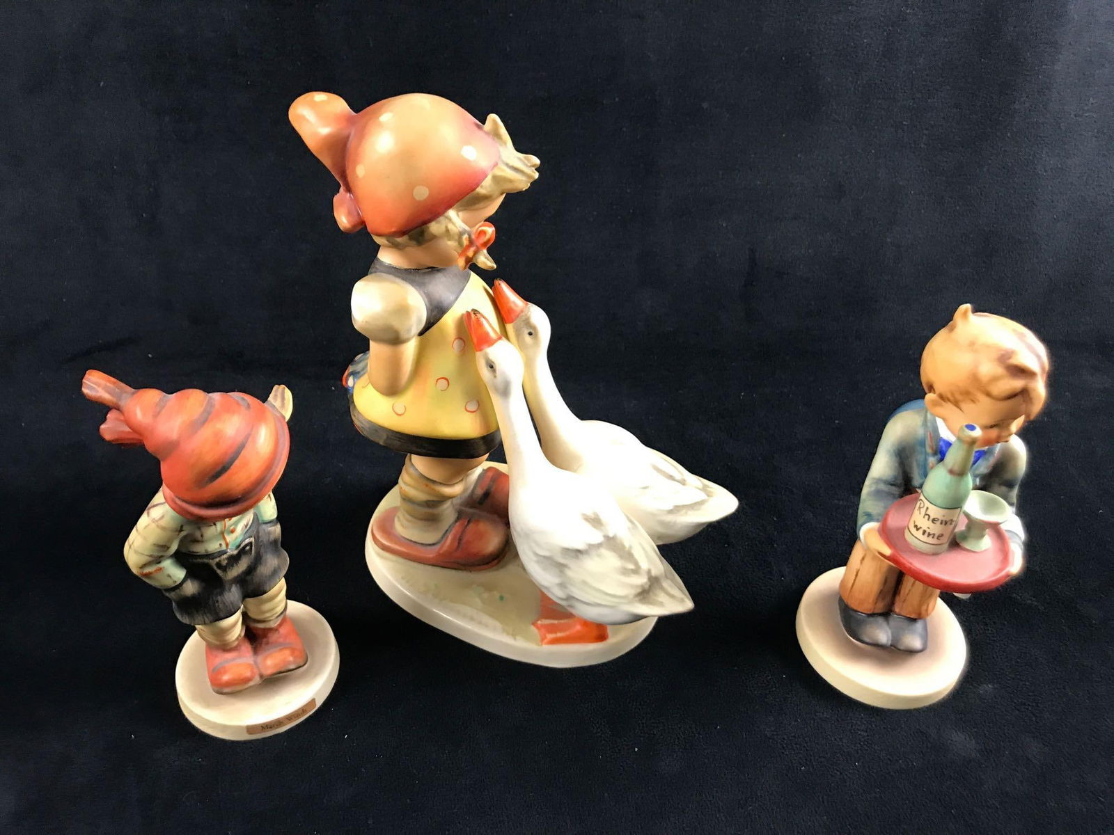 Hummel Figurines Vintage Large Figure Plus Two Reg: Here is a lot of three Goebel Hummel Figurines made in West Germany during the '60s/70's. Hand-painted porous earthenware. This lot includes: (1) March Winds. TMK-3. Is approx 2" x 2 x 5&