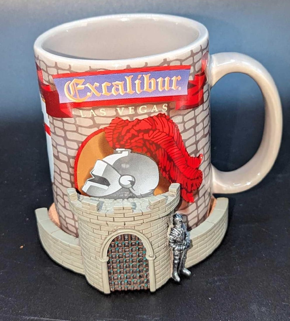 Excalibur Las Vegas Coffee Mug With Castle Coaster B: Excalibur Las Vegas Coffee Mug With Castle Coaster B. The ceramic mug is 5" x 3" x 3 3/4". The resin castle coaster is approx 4" x 3 3/4" x 1 3/4". The total weight is 1.10lb. The mug and coaster have