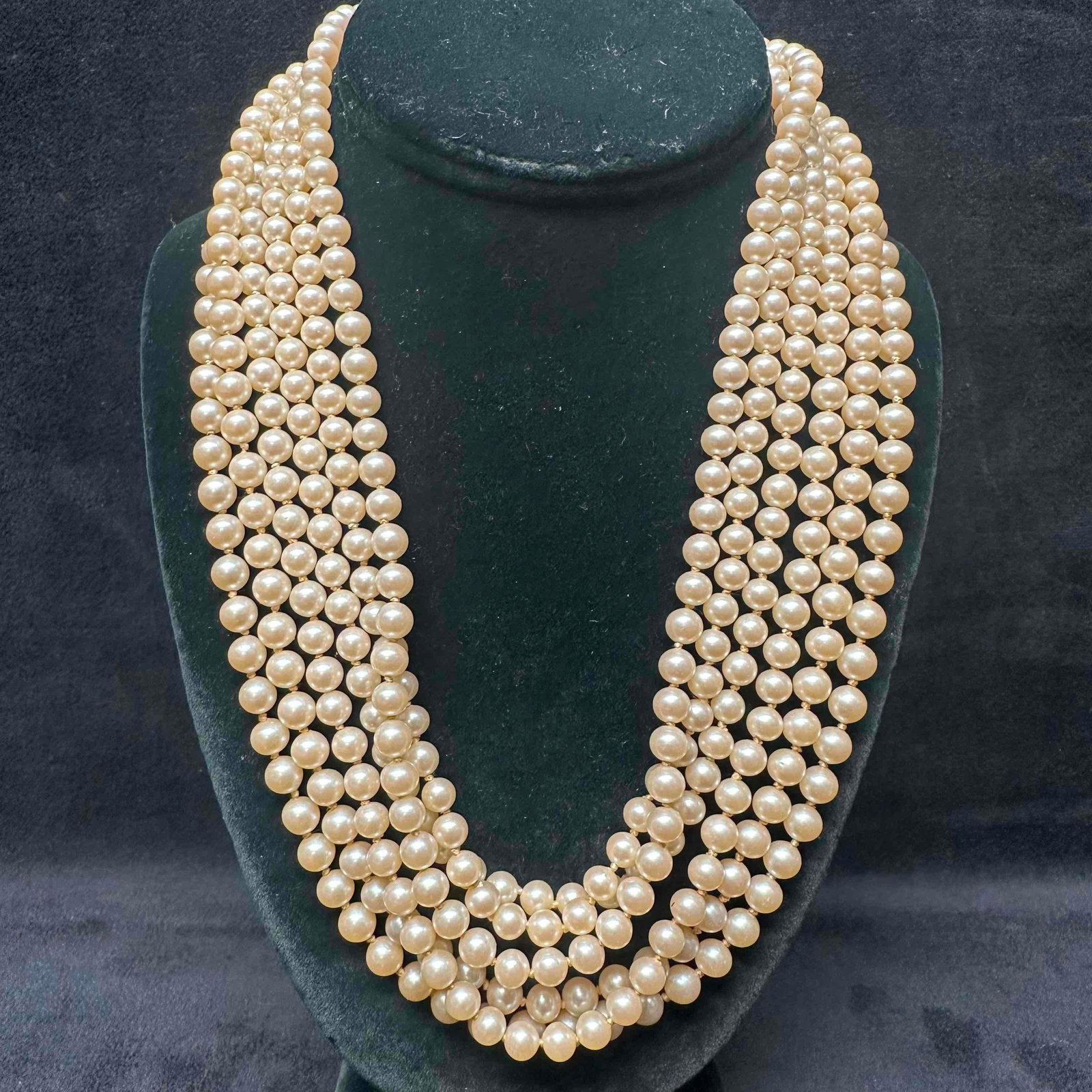Vendome Faux Pearl Six Strand Necklace with Rhinestone Accent Clasp: The necklace features a box clasp closure. Vendome hallmark marking on the clasp. Rhinestone accents on the necklace clasp. This item is in good pre-owned, previously displayed condition with light we