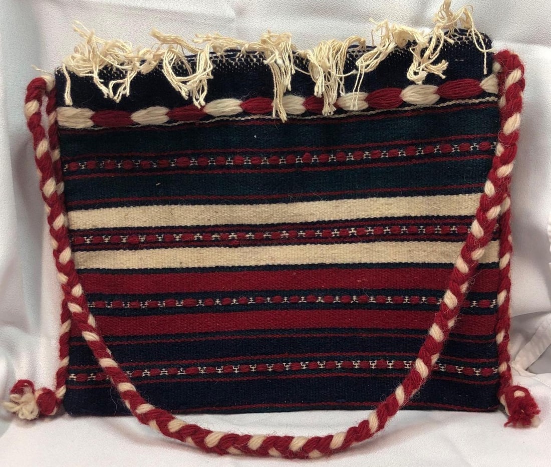 Vintage Handwoven Wool Folk Art Bag: This lot contains a Vintage Handwoven Wool Folk Art Bag with Braided Strap and Fringe Tassels. The wool bag is approx 13" x 10" x 1/2" (27" Strap) and weighs about 0.4lbs. Overall the Vintage Wool Bag