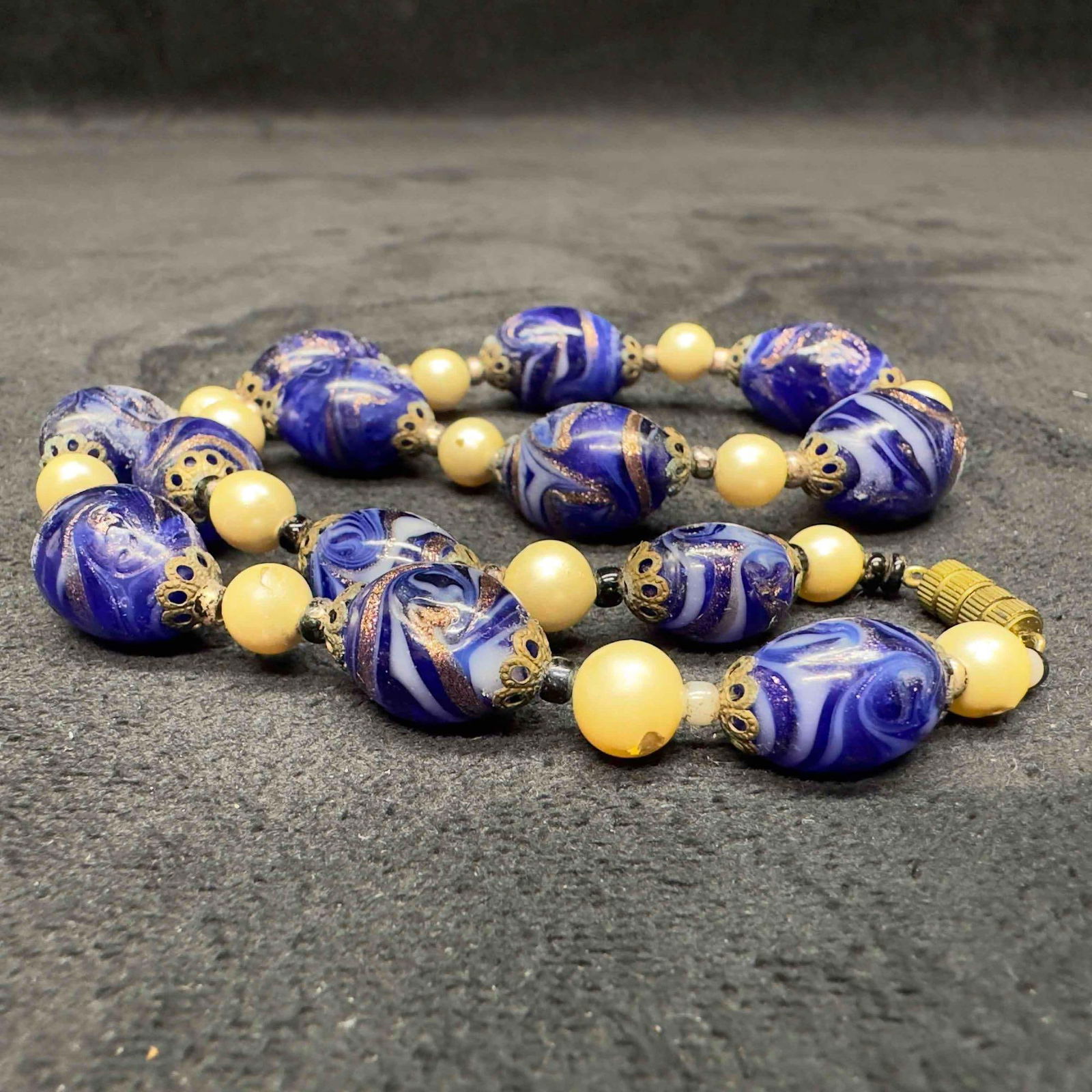 Venetian Murano Glass Lamp Work Blue White Bead Pearl Accents Beaded Necklace B17: Venetian Murano Glass Lamp Work Blue White Bead Pearl Accents Beaded Necklace B17. Necklace with blue and white glass beads with beautiful designs on each. The necklace features pearl colored accents.