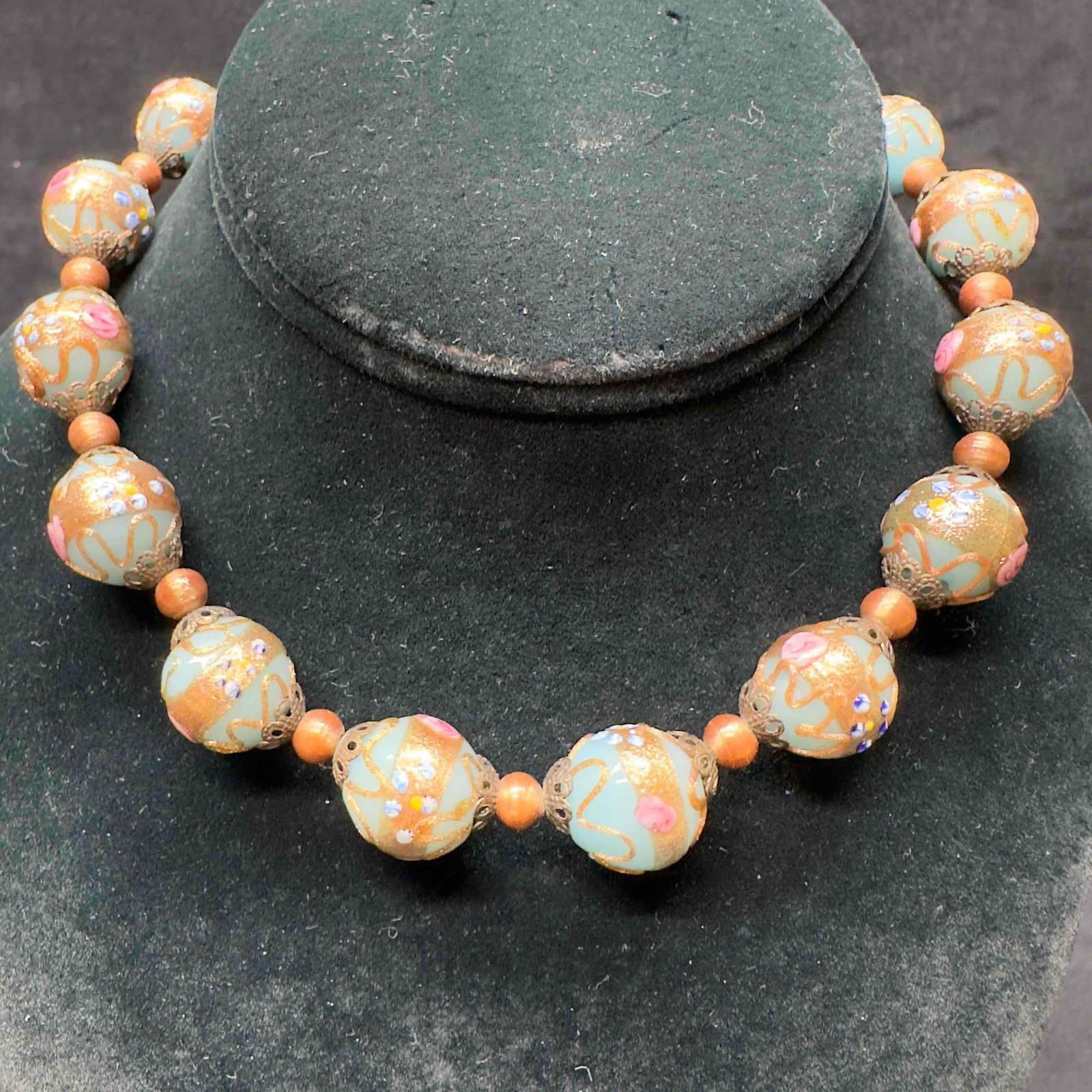 Venetian Murano Lamp Work Glass Blue Bead Fiorato Floral Beaded Necklace A94: Venetian Murano Lamp Work Glass Blue Bead Fiorato Floral Beaded Necklace A94. Necklace with blue glass beads with beautiful designs on each. The necklace features copper and floral accents. The neckla