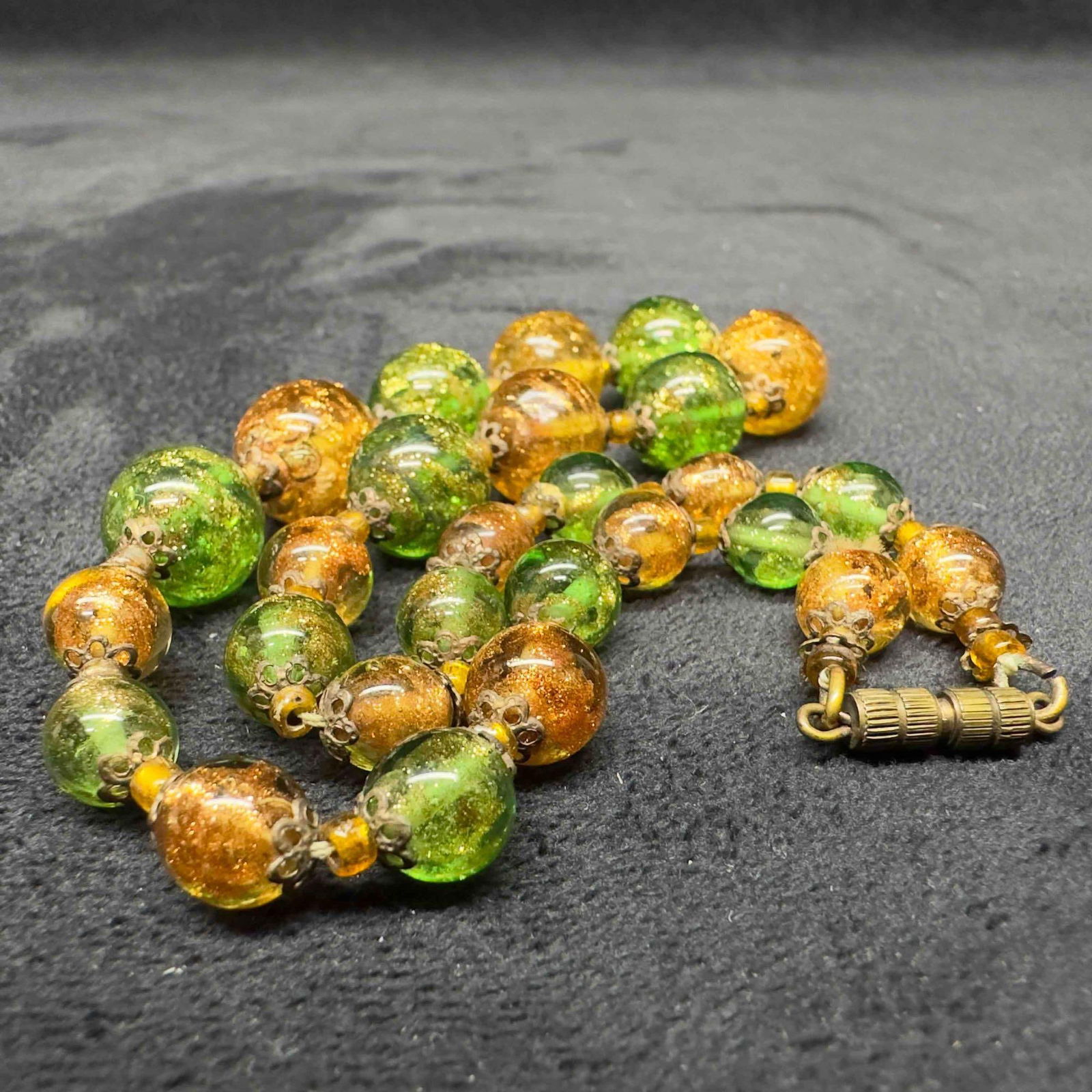 Venetian Murano Glass Lamp Work Bead Green Yellow Copper Accent Beaded Necklace B20: Venetian Murano Glass Lamp Work Bead Green Yellow Copper Accent Beaded Necklace B20. Necklace with clear yellow and green colored glass beads with beautiful designs on each. The necklace features copp