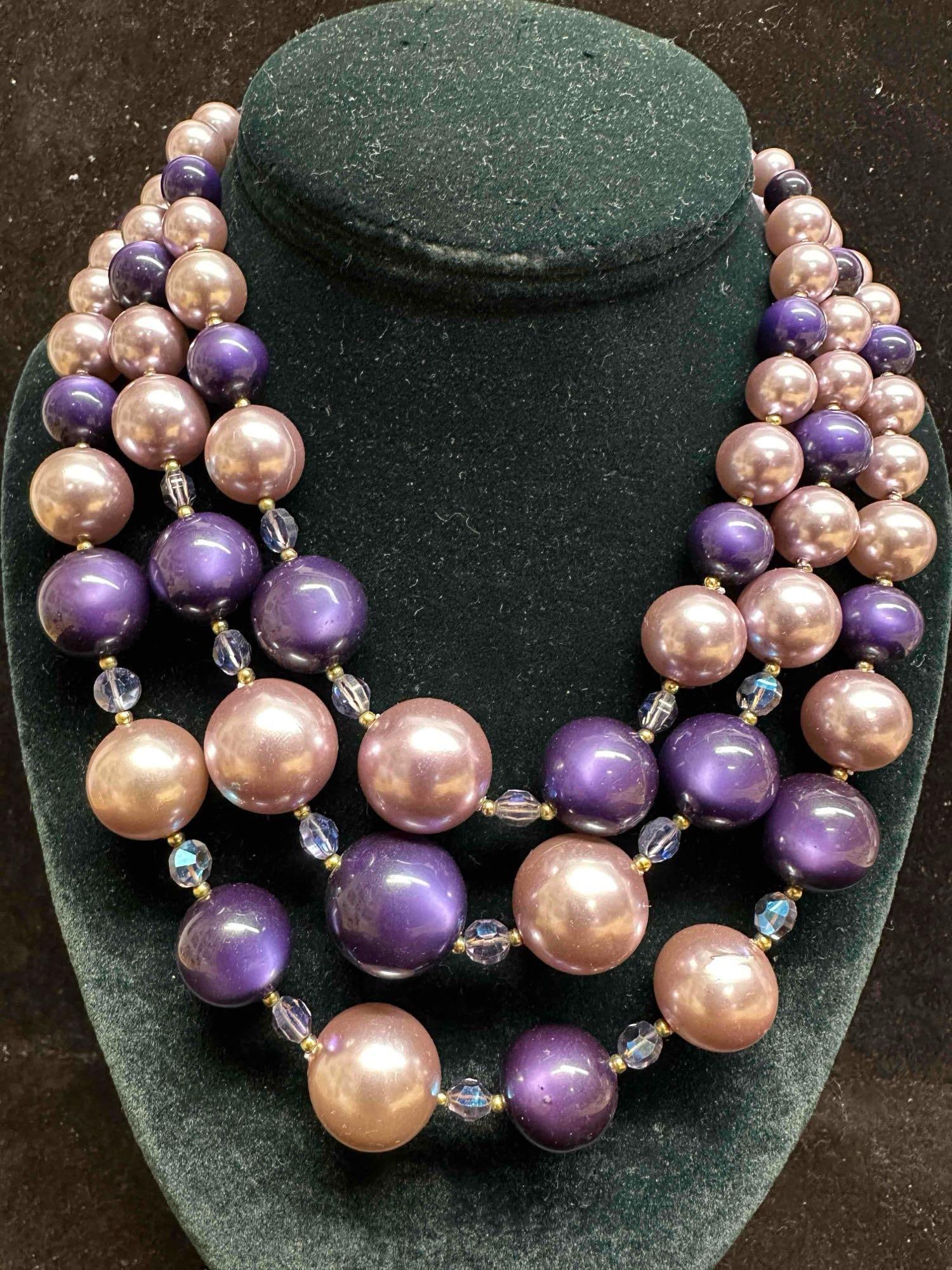 1950's Vintage MCM Purple Mauve Triple Strand Necklace Glam Costume Jewelry: Necklace with dark and light purple beads with beautiful designs on each. The necklace features a j hook clasp closure. This item is in good pre-owned, previously displayed condition with light wear,