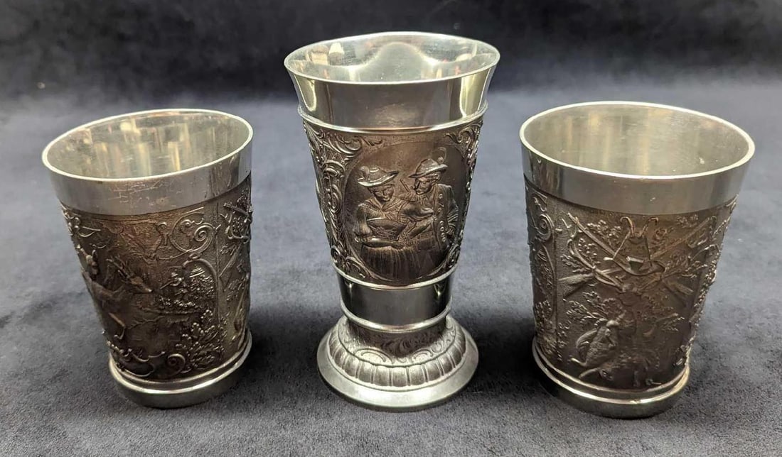 3 Vintage German Zinn Becker Pewter Cups: 3 Vintage German Zinn Becker Pewter Cups. There is one "wine cup" which is approx 3" x 2 7/8" x 5 3/8". There are two cups that are approx 3" x 3" x 4 4 1/4". Together they weigh 1.87lb. The cups are