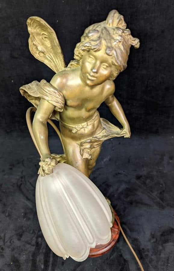 Vintage After Louis Auguste Moreau Cherub Lamp: Vintage After Louis Auguste Moreau Cherub Lamp. This spelter lamp has a bronze patina and an glass tulip shade. The lamp was tested and it works. It is approx 6" x 6" x 20 1/2" and it weighs 14.5