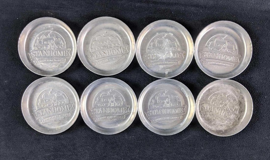 Stanhome Aluminum Coasters: Stanhome Aluminum Coasters This is a set of 8 Stanhome coasters. The coasters are made from aluminum with a house design that says "Standhome, a Stanley home product". These coasters are in go